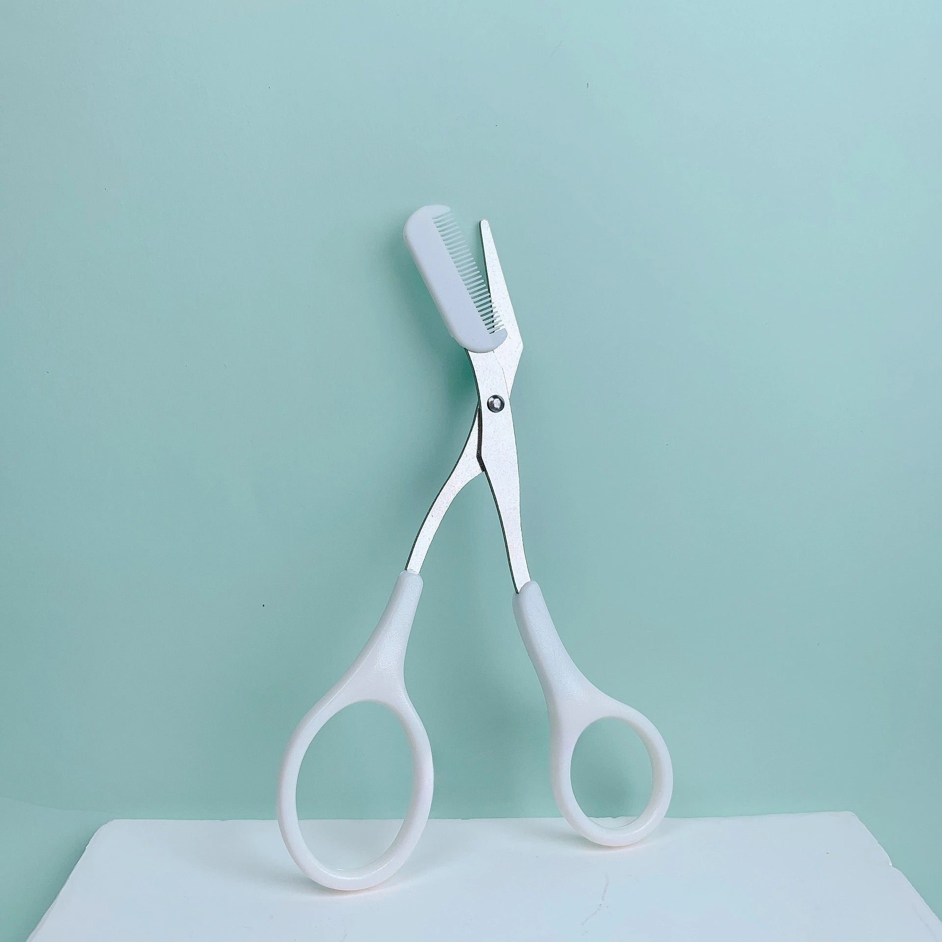 Pink eyebrow trimming scissors with built-in comb - stainless steel, creating perfect eyebrows